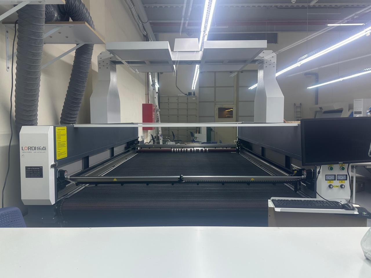 Laser cutting equipment at the AL RUQIU abaya factory in Ajman